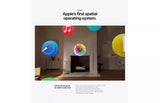 Advertisement for Apple's spatial operating system with colorful app icons in a room setting.